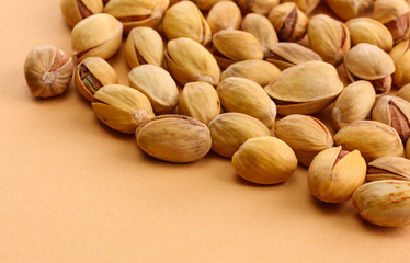 tasty pistachio nuts, on beige background