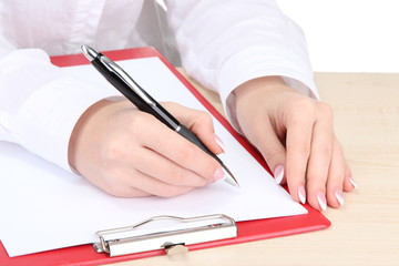 Closeup of businesswoman hands, writing on paper