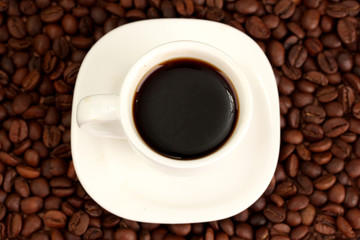 Cup of coffee on brown background