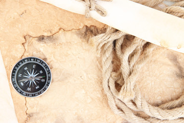 Old paper with compass and rope close up