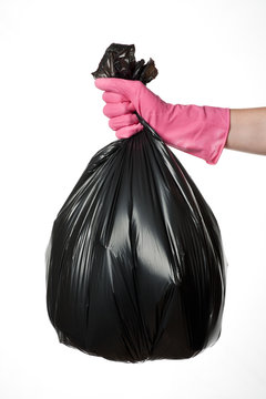 Hand holding trash bag