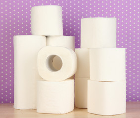Rolls of toilet paper on purple with dots background