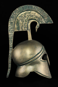 Ancient greek helmet replica on black background