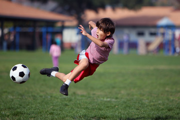 Boy playing soccer in the park