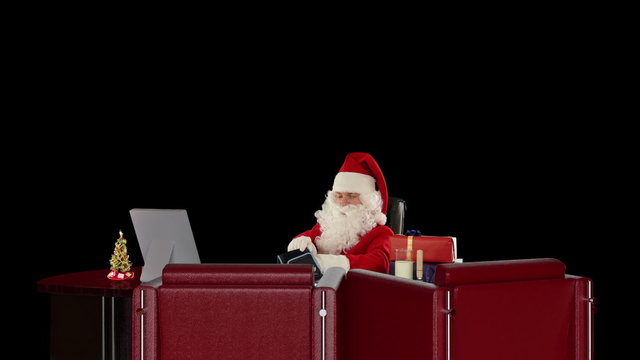 Santa Claus having a migraine, checking blood pressure, on black