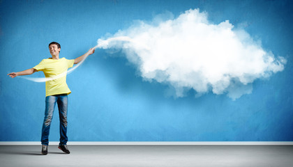 Smiling young casual man on blue background