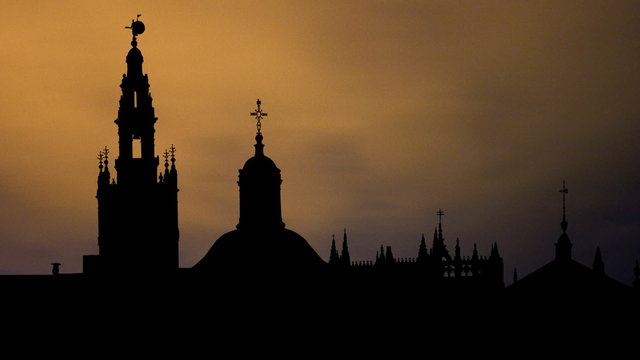 Spain Seville Cathedral and Giralda Tower night clouds