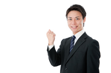 片手でガッツポーズをする若いビジネスマン