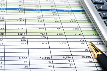 Financial forms with pen and calculator.