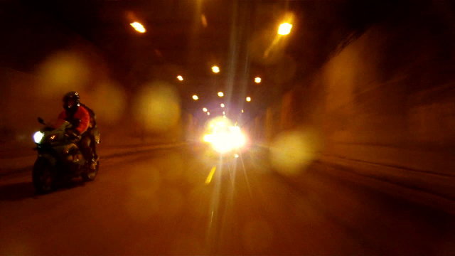Bikers driving through a tunnel