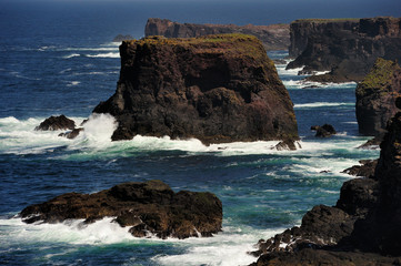 Rocky coast with cliffs and splashing water at Esha Ness.