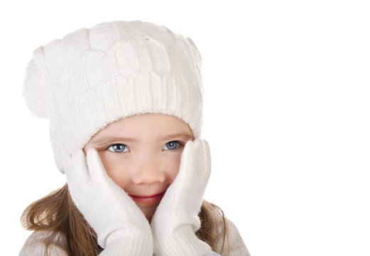 Cute little girl in warm hat and gloves closing her cheks isolat