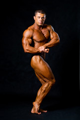 Fototapeta na wymiar A male bodybuilder flexing his muscles