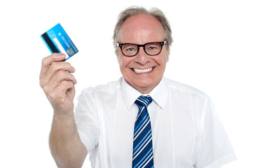 Cheerful aged employer holding up a cash card