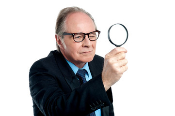 Detective exploring through a magnifying glass