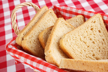 Sliced bread in basked , checked background