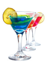 Three colorful drinks in cocktail glasses, isolated
