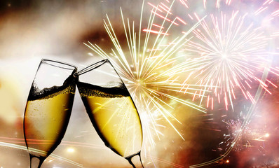 champagne glasses against  fireworks