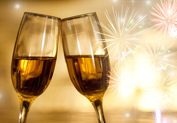 champagne glasses against  fireworks