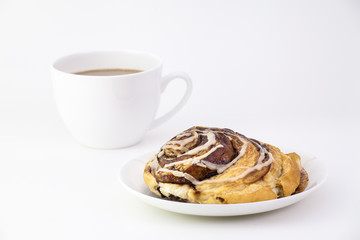 cinnamon bun and a cup of coffee