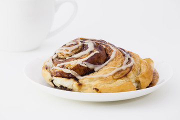 cinnamon bun and coffee cup