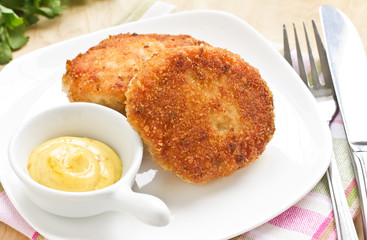 Chicken cutlets on white plate