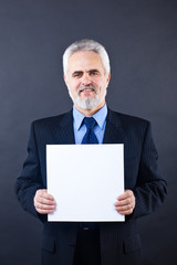 Handsome business man holding blank card