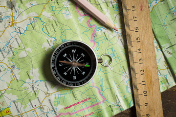 Compass, ruler and pencil on a road map