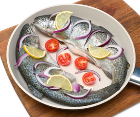 trout and vegetables in a pan