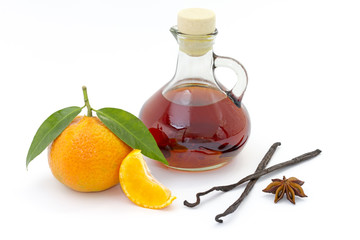 Bottle of liquor with mandarin, anise & vanilla pod