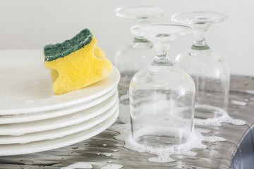 Washing glasses and plates with detergent and water