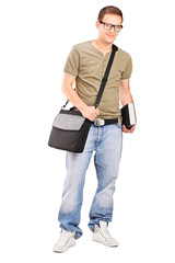 Male student with shoulder bag holding a book