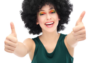 Woman with afro showing thumbs up