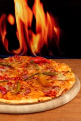 Foto op Plexiglas Tasty pepperoni pizza on wooden board on flame background © Africa Studio