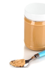 Delicious peanut butter in jar isolated on white