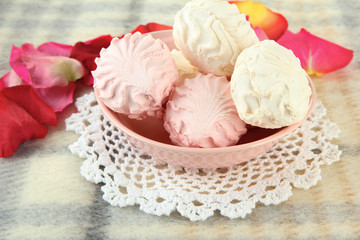 Marshmallows on color plate on light background