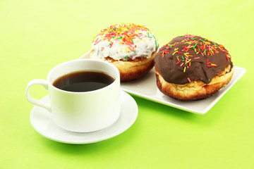 Tasty donuts on color plate on color background