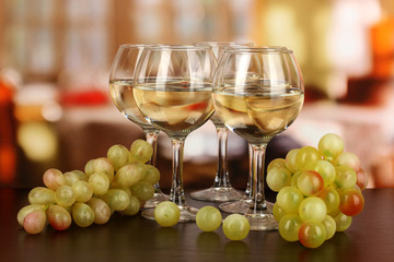 White wine in glass on room background