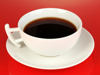 A cup of strong coffee on red background