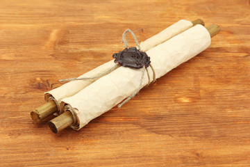 Fototapeta na wymiar Old scroll, on wooden background