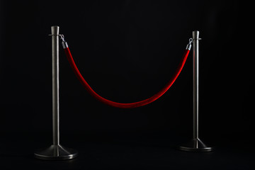 Silver stanchions with red rope