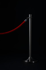 Single silver stanchion with red rope