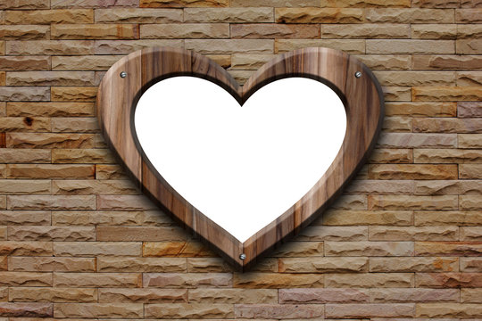 heart shape wooden frame on bricks wall
