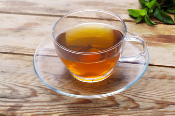 Cup with green tea and fresh herbs