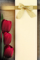 Empty banner and red tulips on vintage background