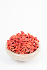 dried wolfberry fruit in bowl on white background