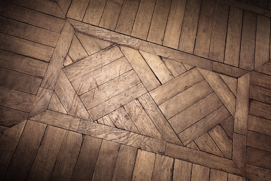 Old oak parquet fragment with decoration element