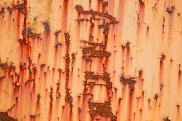 part of old weathered metal with orange paint