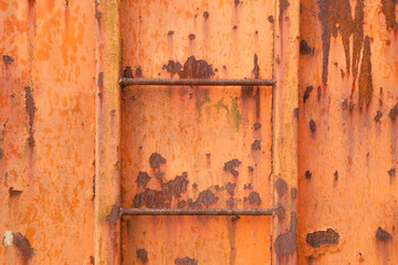 steps of old orange and rusty container