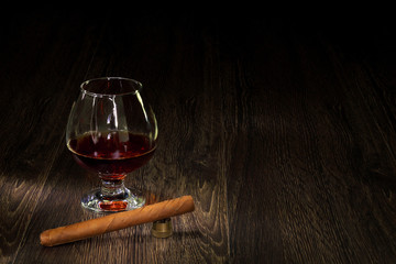 Cognac, cigar and an old book nearby